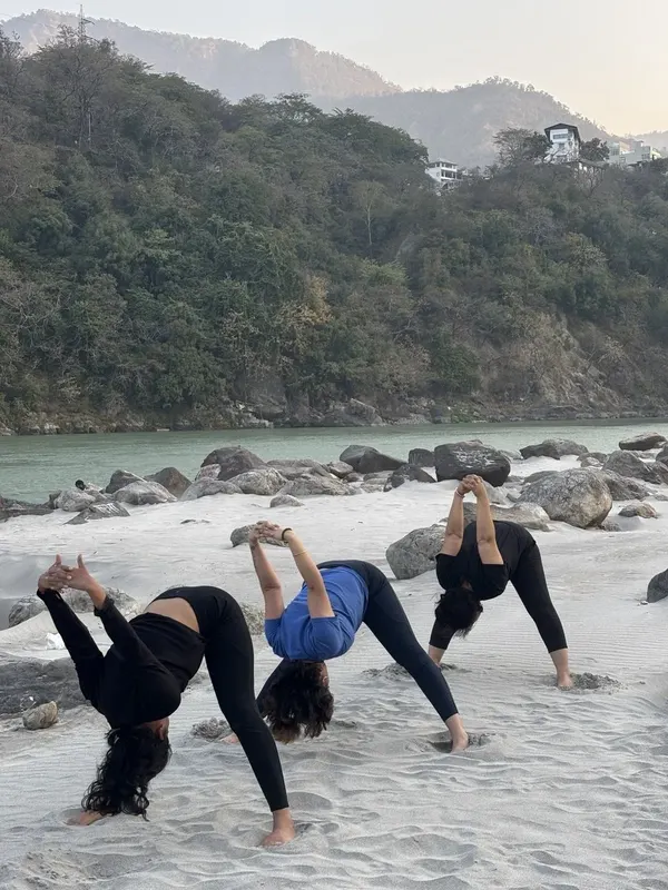 Group Warrior Pose Vinyasa Flow on Ganges Riverbank
